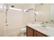 Bright bathroom featuring a single sink vanity, a large mirror, and shower-over-tub combo with neutral tile at 10147 Aspen Rose St # 101, Las Vegas, NV 89183