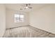Comfortable bedroom featuring neutral carpet, a ceiling fan, and a window with neighborhood views at 10147 Aspen Rose St # 101, Las Vegas, NV 89183