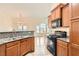 Open kitchen featuring granite counters, stainless appliances, dark wood cabinets, open to living space at 10147 Aspen Rose St # 101, Las Vegas, NV 89183