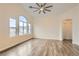 Spacious, open living area with vaulted ceilings, large windows, and modern wood-look flooring at 10147 Aspen Rose St # 101, Las Vegas, NV 89183
