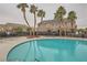 Community pool features palm trees and plenty of seating at 10147 Aspen Rose St # 101, Las Vegas, NV 89183