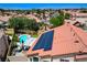 This aerial view showcases a home featuring solar panels and a beautiful backyard pool and patio area at 1028 Dodger Blue Ave, Las Vegas, NV 89123