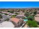 Expansive aerial view of a home with a backyard pool, highlighting the neighborhood and mountain views at 1028 Dodger Blue Ave, Las Vegas, NV 89123