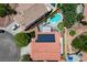 An aerial of this home showcases the backyard pool, patio, and putting green, plus solar panels at 1028 Dodger Blue Ave, Las Vegas, NV 89123