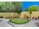 Backyard with a charming putting green surrounded by greenery and attractive landscaping at 1028 Dodger Blue Ave, Las Vegas, NV 89123