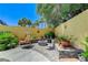 Relaxing backyard featuring a cozy seating area, a fire pit, and beautiful landscaping at 1028 Dodger Blue Ave, Las Vegas, NV 89123