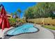 Luxurious backyard with a private pool, waterfall feature, and lush tropical landscaping at 1028 Dodger Blue Ave, Las Vegas, NV 89123