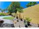 Lush backyard offers a putting green and a variety of trees and plants for a private outdoor experience at 1028 Dodger Blue Ave, Las Vegas, NV 89123