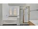 Bright bathroom features a soaking tub under a bay window and walk-in shower at 1028 Dodger Blue Ave, Las Vegas, NV 89123