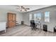 Bright bedroom with a ceiling fan, wood floors, and a writing desk at 1028 Dodger Blue Ave, Las Vegas, NV 89123