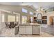 Updated kitchen flows into a dining area and living room with high ceilings and natural light at 1028 Dodger Blue Ave, Las Vegas, NV 89123