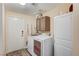 A well lit laundry room with wood floors and ample cabinet space at 1028 Dodger Blue Ave, Las Vegas, NV 89123