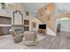 Spacious living room with a fireplace, plush seating, and a staircase leading to the second floor at 1028 Dodger Blue Ave, Las Vegas, NV 89123