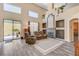 Grand living room with a fireplace, vaulted ceilings, large windows, and hardwood floors at 1028 Dodger Blue Ave, Las Vegas, NV 89123