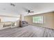 Spacious loft with wood-look flooring, a ceiling fan, and comfortable seating at 1028 Dodger Blue Ave, Las Vegas, NV 89123