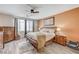 Spacious main bedroom with wood-look floors, ceiling fan, and ample natural light creating a cozy retreat at 1028 Dodger Blue Ave, Las Vegas, NV 89123