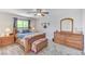Well lit main bedroom with wood floors and an ample dresser and end tables at 1028 Dodger Blue Ave, Las Vegas, NV 89123