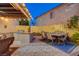 A stylish outdoor kitchen and dining area for entertaining guests, featuring a built-in grill and comfortable seating at 1028 Dodger Blue Ave, Las Vegas, NV 89123