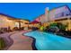 Resort-style backyard featuring a refreshing pool, outdoor kitchen, patio, and lush landscaping at 1028 Dodger Blue Ave, Las Vegas, NV 89123