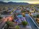Panoramic aerial view of desert community with homes and scenic mountain backdrop at 10319 Larkmead Ave, Las Vegas, NV 89149