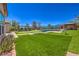 Green backyard featuring lush artificial turf, an outdoor bar, putting green, and inviting lounge areas at 10319 Larkmead Ave, Las Vegas, NV 89149