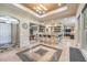 Open bar area with stone floors, bar seating, custom shelving and a billiard table in the background at 10319 Larkmead Ave, Las Vegas, NV 89149