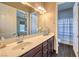 Well-lit bathroom with a single sink vanity, shower, and linen closet at 10319 Larkmead Ave, Las Vegas, NV 89149