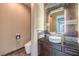 Modern bathroom featuring a vessel sink, contemporary fixtures, decorative mirror, and tiled walls at 10319 Larkmead Ave, Las Vegas, NV 89149