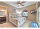 Comfortable bedroom featuring a mounted TV, window seat, and en suite bathroom at 10319 Larkmead Ave, Las Vegas, NV 89149