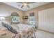Bright bedroom featuring a ceiling fan, mounted TV, and slider closet at 10319 Larkmead Ave, Las Vegas, NV 89149