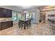 Dining area with elegant lighting, dark wood cabinets, and seamless transition to the outdoor living space at 10319 Larkmead Ave, Las Vegas, NV 89149