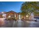 Beautiful single-story home featuring a tiled roof, brick driveway and desert landscaping at 10319 Larkmead Ave, Las Vegas, NV 89149