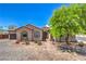 Charming home featuring a paved driveway, desert landscaping, and an arched entryway at 10319 Larkmead Ave, Las Vegas, NV 89149