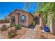 Close up of charming home with an arched entryway, desert landscaping, and a brick walkway at 10319 Larkmead Ave, Las Vegas, NV 89149