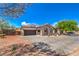 Charming home featuring a paved driveway, a three car garage, desert landscaping and solar panels at 10319 Larkmead Ave, Las Vegas, NV 89149