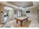 This game room features a beautiful pool table, tiled floors and recessed lighting at 10319 Larkmead Ave, Las Vegas, NV 89149