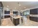 Gourmet kitchen with granite island, stainless steel appliances, and view of the open-concept living spaces at 10319 Larkmead Ave, Las Vegas, NV 89149