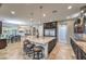 Open kitchen with spacious island, breakfast bar, dark wood cabinets, and stainless steel appliances at 10319 Larkmead Ave, Las Vegas, NV 89149