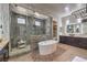 This main bathroom features a walk-in shower, tub, and double vanity at 10319 Larkmead Ave, Las Vegas, NV 89149