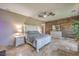The main bedroom features tiled flooring, a ceiling fan, and an accent wall at 10319 Larkmead Ave, Las Vegas, NV 89149