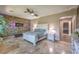 The main bedroom features tiled flooring, a ceiling fan, and an accent wall at 10319 Larkmead Ave, Las Vegas, NV 89149
