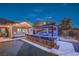 Outdoor bar area with ample seating, a built-in grill, and a putting green in the landscaped backyard at 10319 Larkmead Ave, Las Vegas, NV 89149