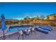 Relax and unwind at night next to the spa, pool, outdoor seating, and covered pergola in this backyard at 10319 Larkmead Ave, Las Vegas, NV 89149