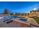 Backyard with refreshing pool, spa, lounge chairs, and covered patio, perfect for relaxing and entertaining at night at 10319 Larkmead Ave, Las Vegas, NV 89149