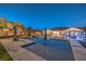 Beautiful backyard showcasing a sparkling pool, covered seating, well-manicured greenery, and landscape lighting at 10319 Larkmead Ave, Las Vegas, NV 89149