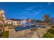 Stunning backyard featuring a pristine pool, spa, covered patio, and lush landscaping, perfect for outdoor entertaining at 10319 Larkmead Ave, Las Vegas, NV 89149