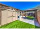 Backyard shed and batting cage offer extra storage and recreation space, with artificial turf at 10319 Larkmead Ave, Las Vegas, NV 89149