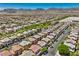 Expansive aerial view of a neighborhood highlighting rows of homes with mountain views at 10353 Yew Blossom Ave, Las Vegas, NV 89166