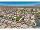 An aerial perspective highlights a residential community with homes and a field in the background at 10353 Yew Blossom Ave, Las Vegas, NV 89166