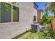 Backyard with artificial grass, plants, table, and AC unit at 10353 Yew Blossom Ave, Las Vegas, NV 89166